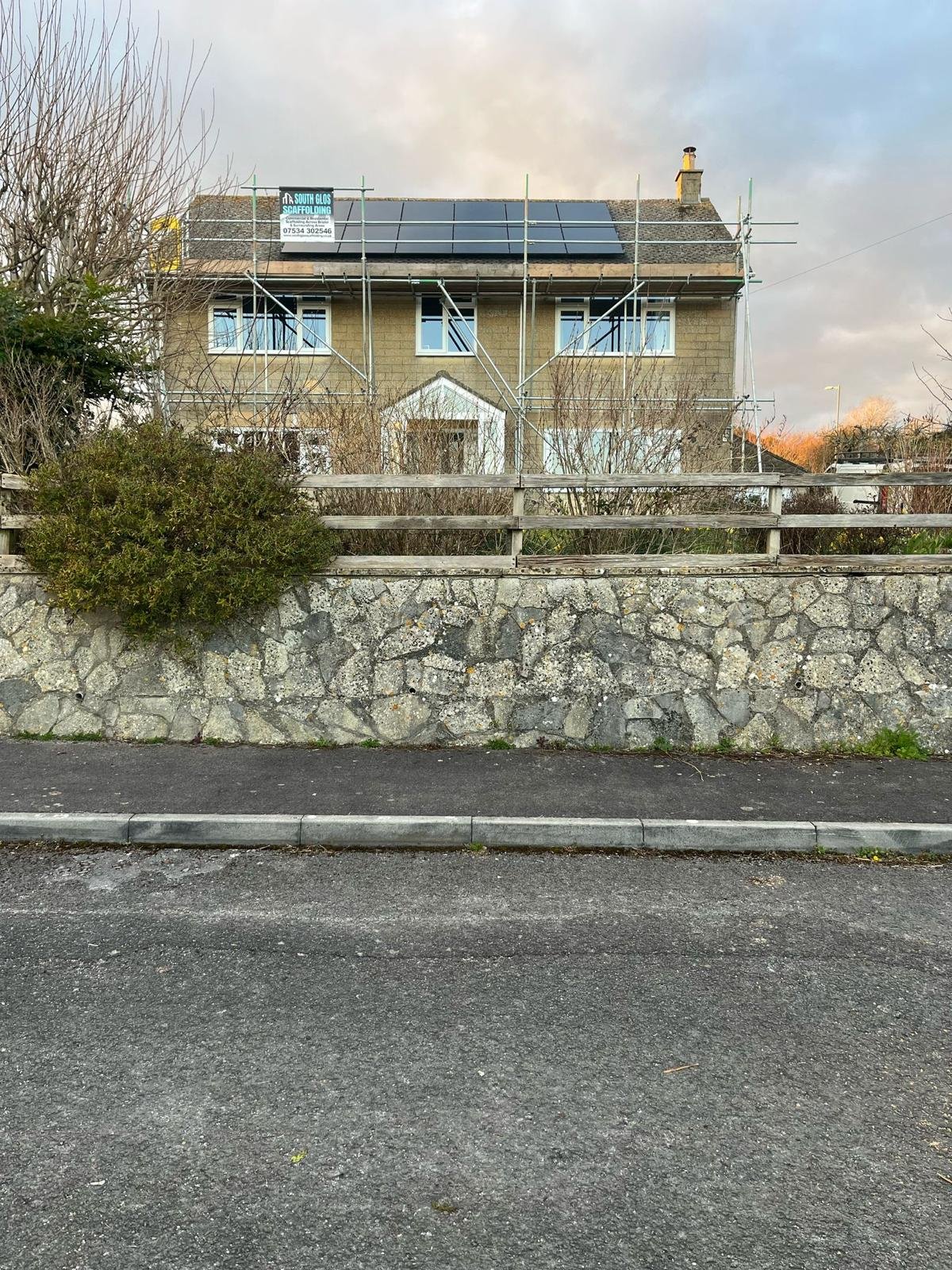 Residential solar panel installation in progress with scaffolding to the roof