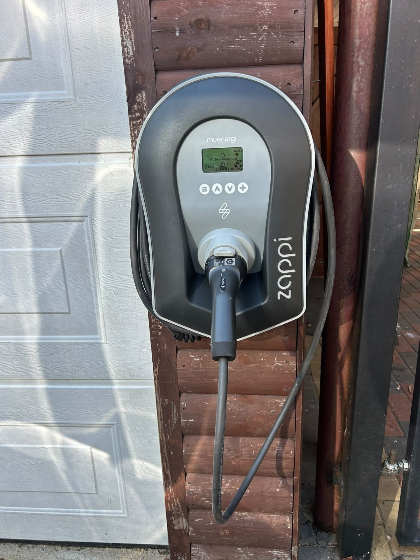 Zappi EV charge point mounted on a garage post in Hampshire