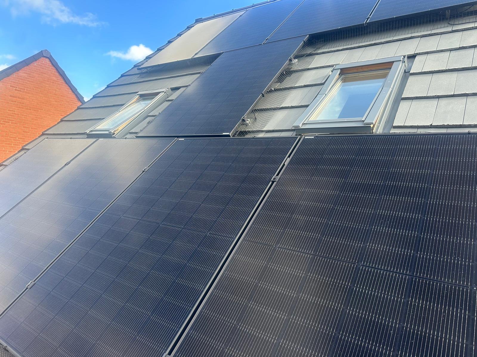 All-black solar panels fitted to a grey tiled roof in Winchester