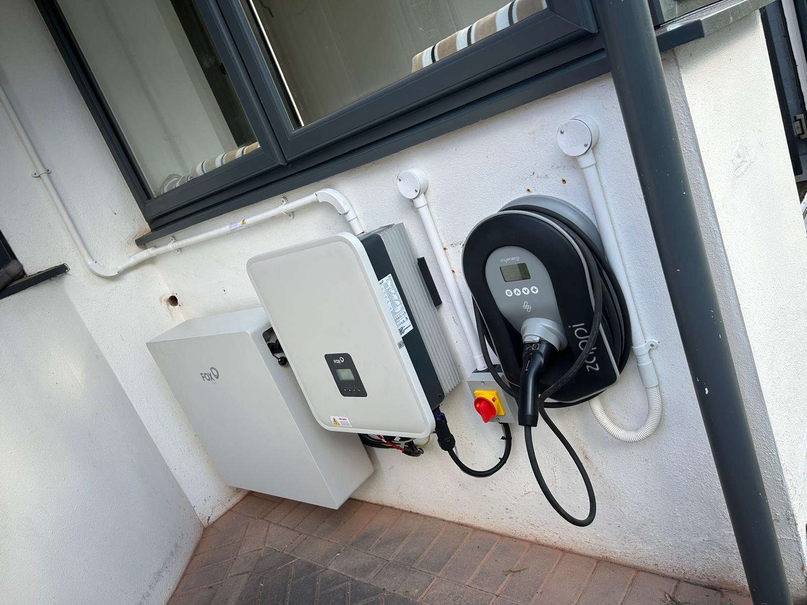 Zappi EV charger installed beside a Fox ESS inverter and battery in Winchester